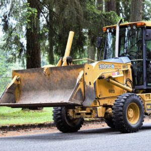 a yellow bulldozer is parked on the side of the road